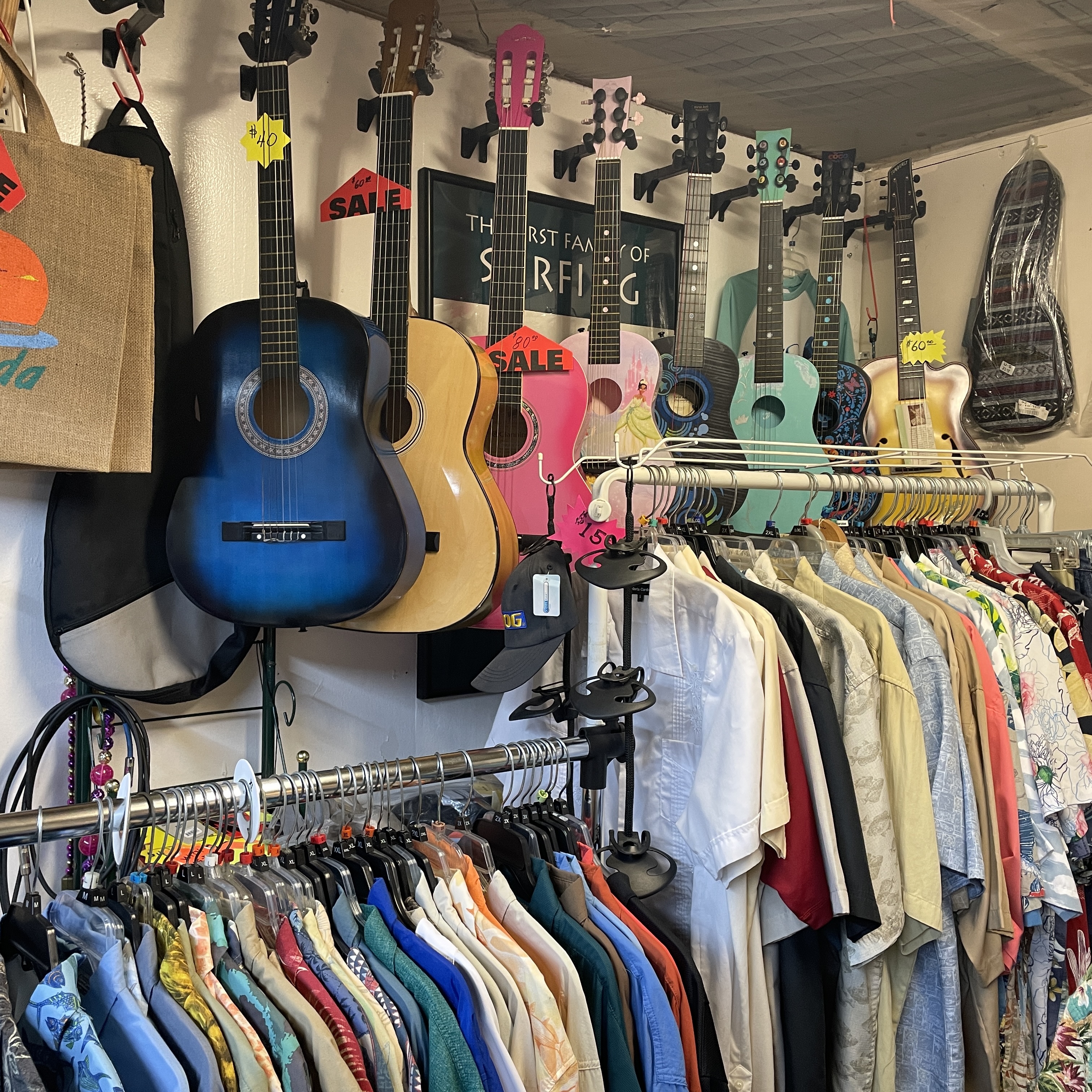 Ukuleles and colorful aloha shirts on display inside Guitar Stan's shop at the Daytona Flea Market Corner Shops Mall.